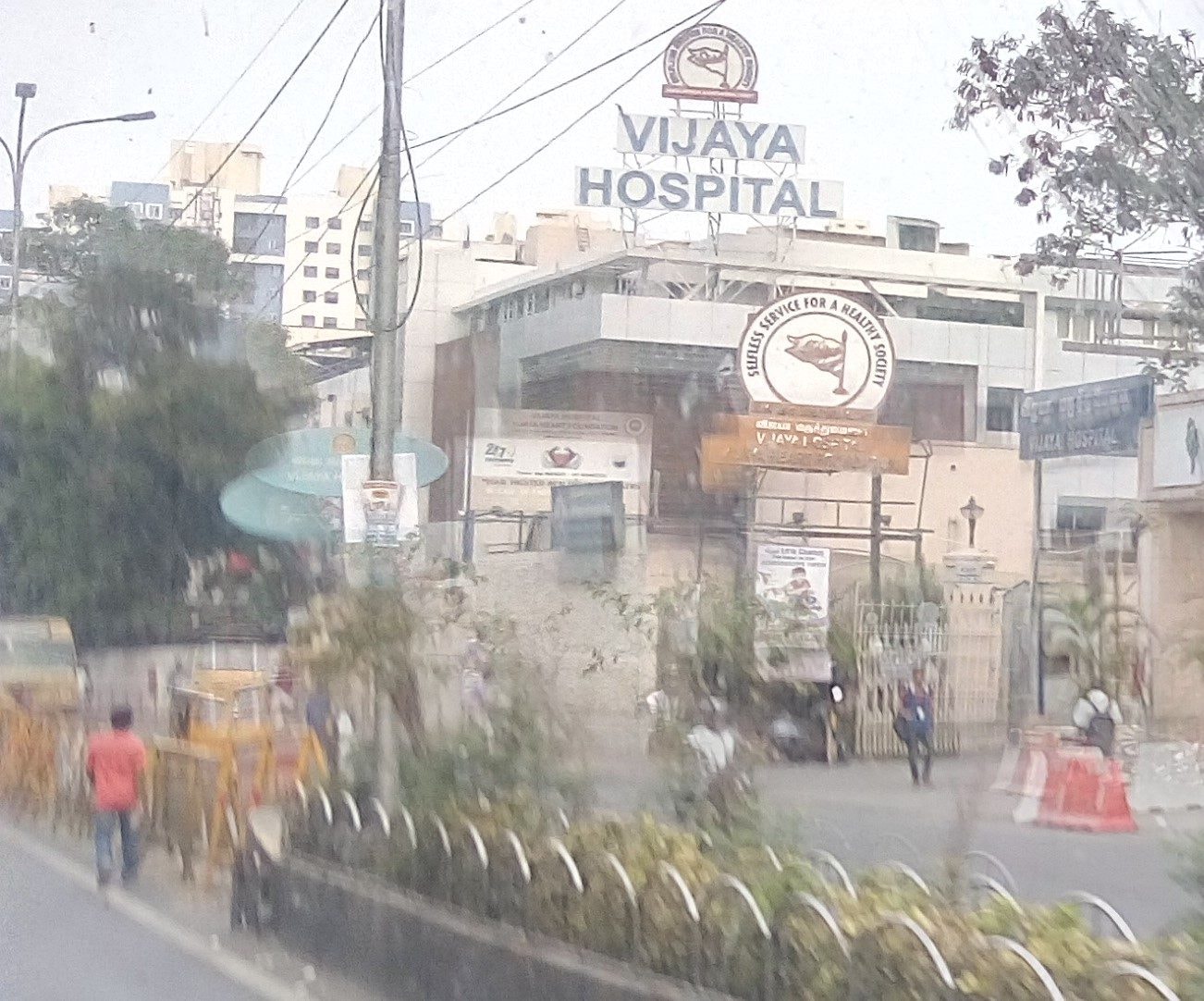 Vijaya Hospital building with its rooftop name sign, seen from the main road in Vadapalani, Chennai